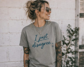A woman wearing a heather grey graphic t-shirt with the text 'I just disagree.